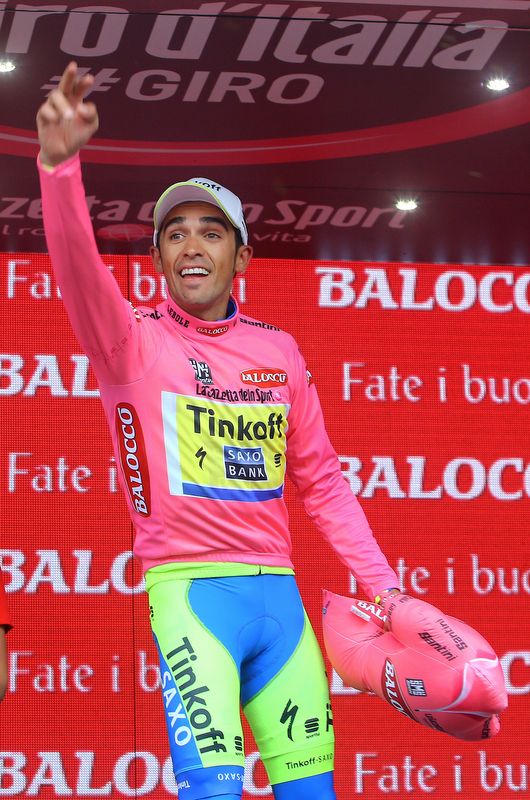 Alberto Contador looking happy on the podium for the first time in a few days since dislocating his shoulder