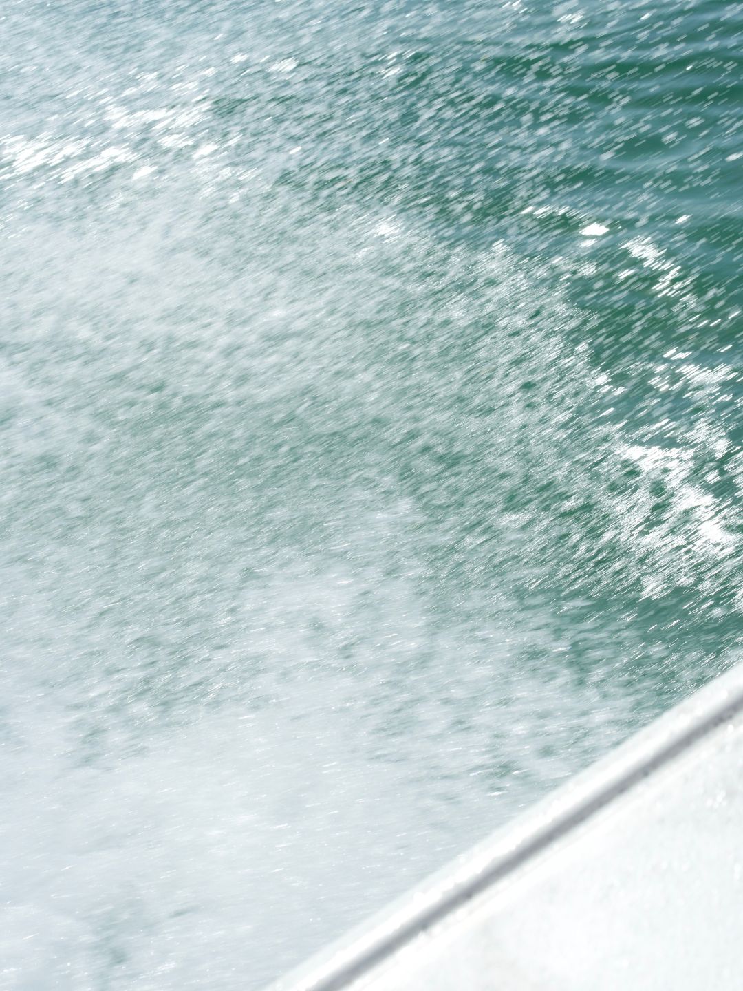 A woman meditating, on the beach, and by the ocean