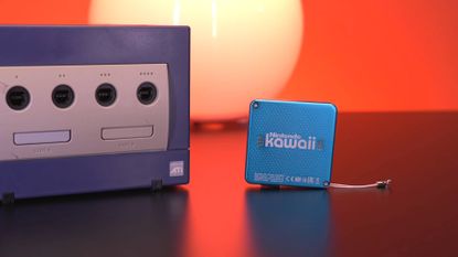 Nintendo Kawaii mini console on right and purple GameCube on left.