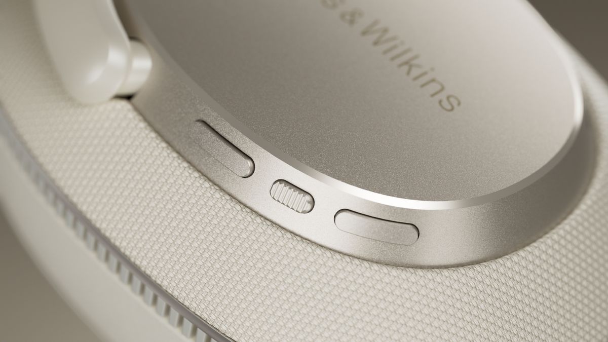 A close up of the controls on the ear cup of a Bowers &amp; Wilkins Px7 S3 headphone