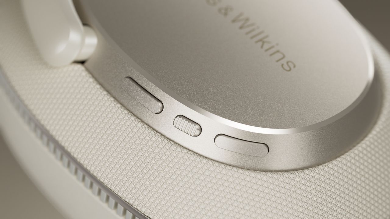 A close up of the controls on the ear cup of a Bowers &amp; Wilkins Px7 S3 headphone