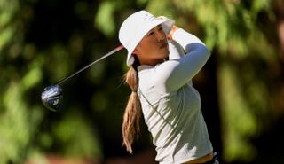 Amy Yang hits a tee shot with a driver and watches it in the air