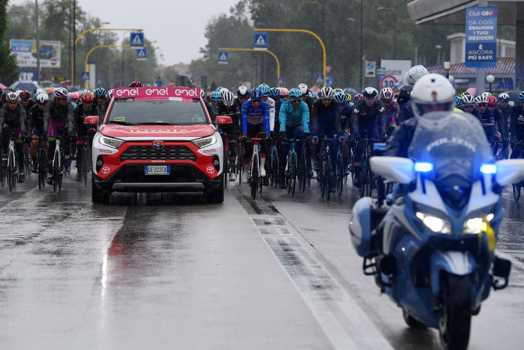 CORTINA DAMPEZZO ITALY MAY 24 Aleksander Vlasov of Russia and Team Astana Premier Tech white best young jersey Geoffrey Bouchard of France and AG2R Citren Team blue mountain jersey the peloton in neutralised start during the 104th Giro dItalia 2021 Stage 16 a 153km stage shortened due to bad weather conditions from Sacile to Cortina dAmpezzo 1210m Rain girodiitalia Giro on May 24 2021 in Cortina dAmpezzo Italy Photo by Tim de WaeleGetty Images