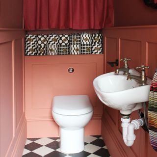 Terracotta painted small downstairs loo with DIY wall panelling