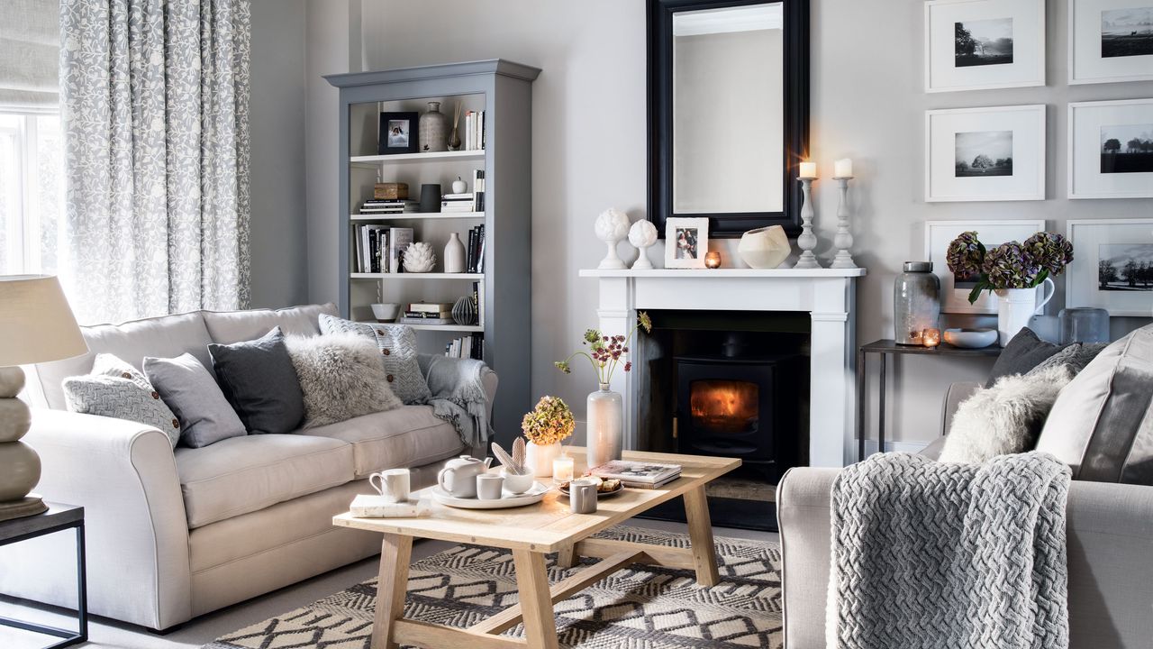 Neutral grey room with white sofas and faux fur cushions