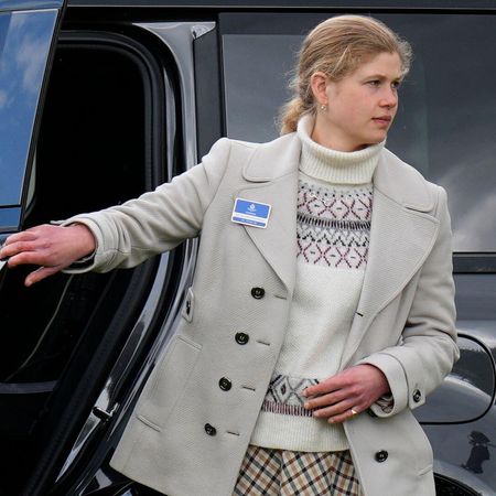 Lady Louise wearing a fairisle sweater and blazer walking out of a car