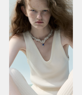 woman with red hair wearing jewellery