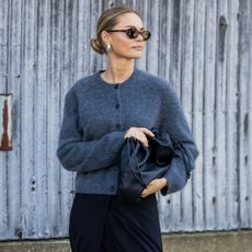 Woman in gray cardigan and skirt