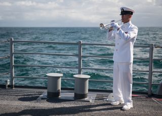 Chief Musician for the United States Navy Band, Gunnar Bruning, plays taps during the burial at sea service for Apollo 11 astronaut Neil Armstrong aboard the USS Philippine Sea (CG 58), Friday, Sept. 14, 2012, in the Atlantic Ocean.