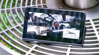 Google Pixel Fold shown folded displaying a movie trailer