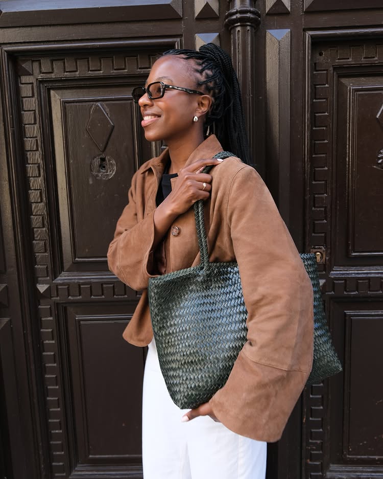 Taffy Msipa wears a leather woven shoulder bag.