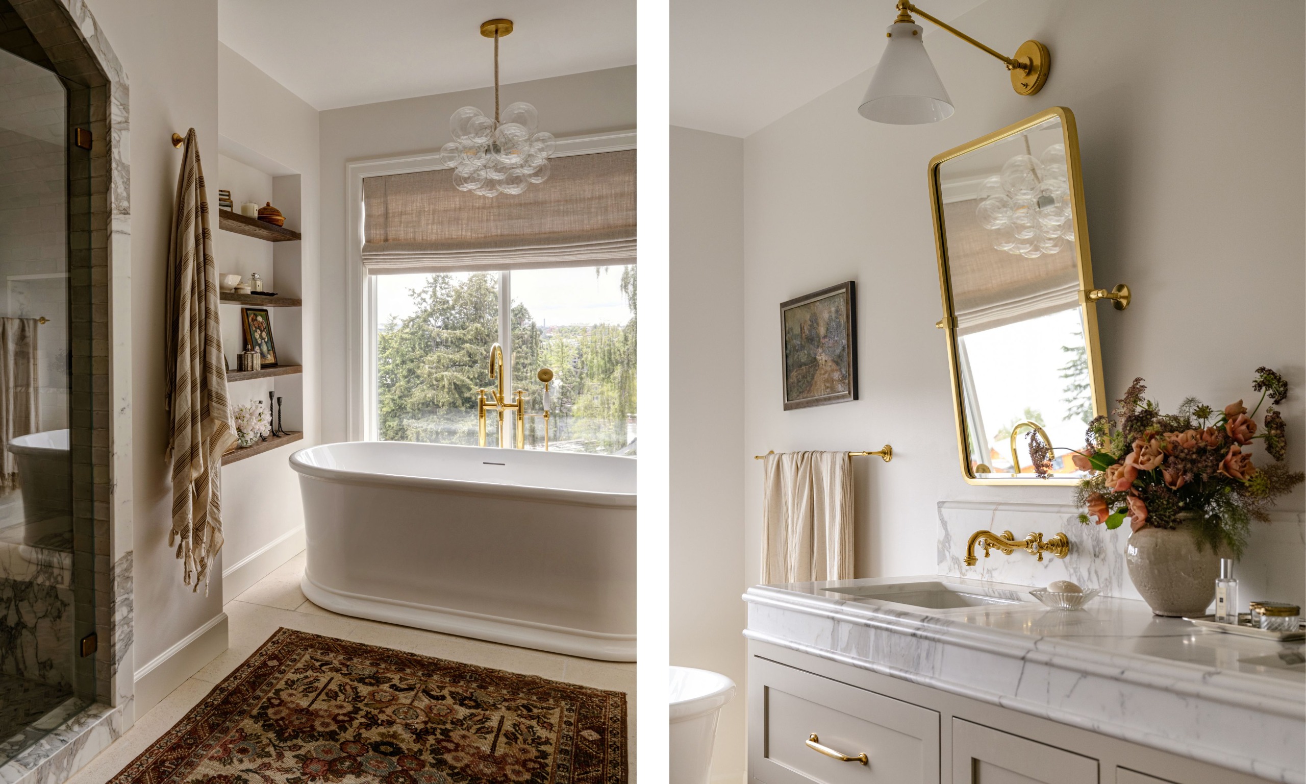 Two images of a bathroom with warm white walls, a large white bathtub in front of a large window with neutral Roman blinds. A vintage rug, an enclosed marble shower, a beige vanity with double sinks, marble counters, and brass fixtures.