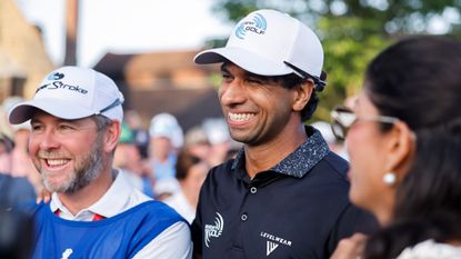 Aaron Rai smiles with his caddie after winning the 2026 PGA Championship