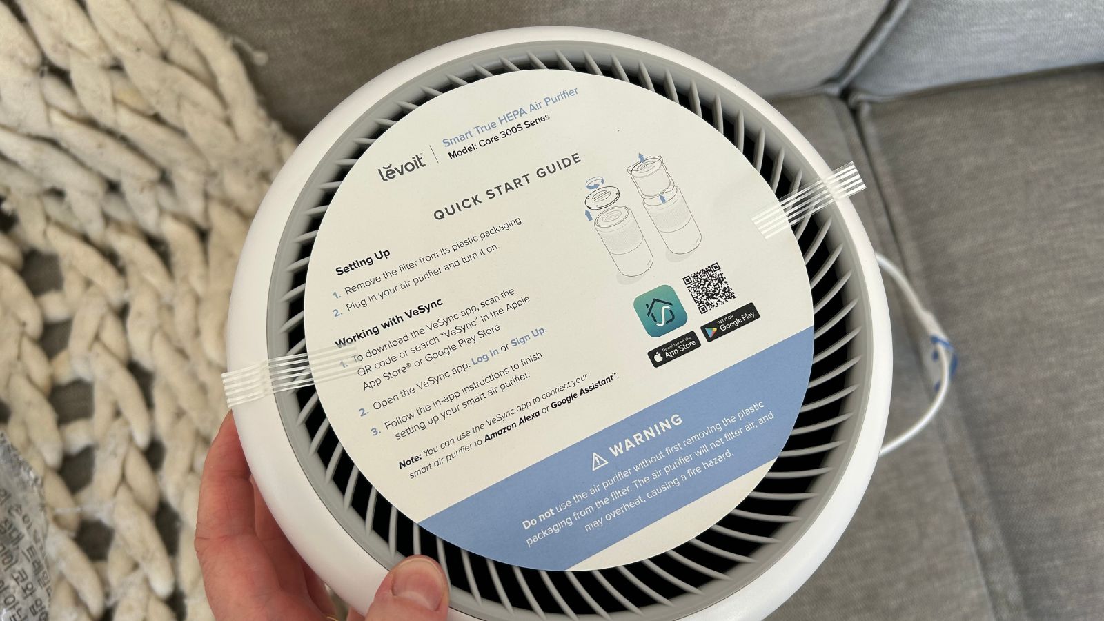 Levoit air purifier setup with information leaflet on screen
