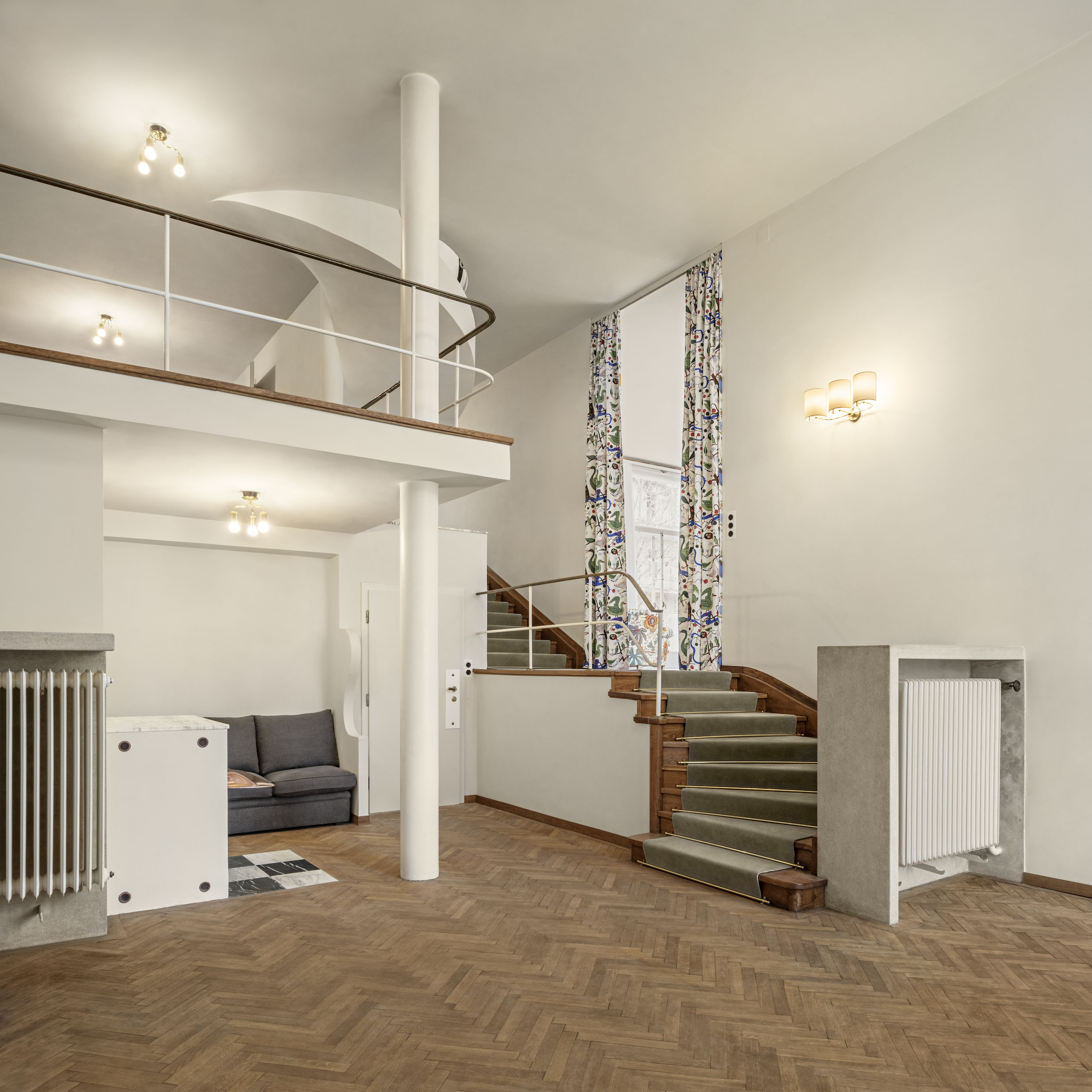 interiors of Villa Beer showing the house restored and clean, sparsely furnished showing off white walls and key furniture pieces