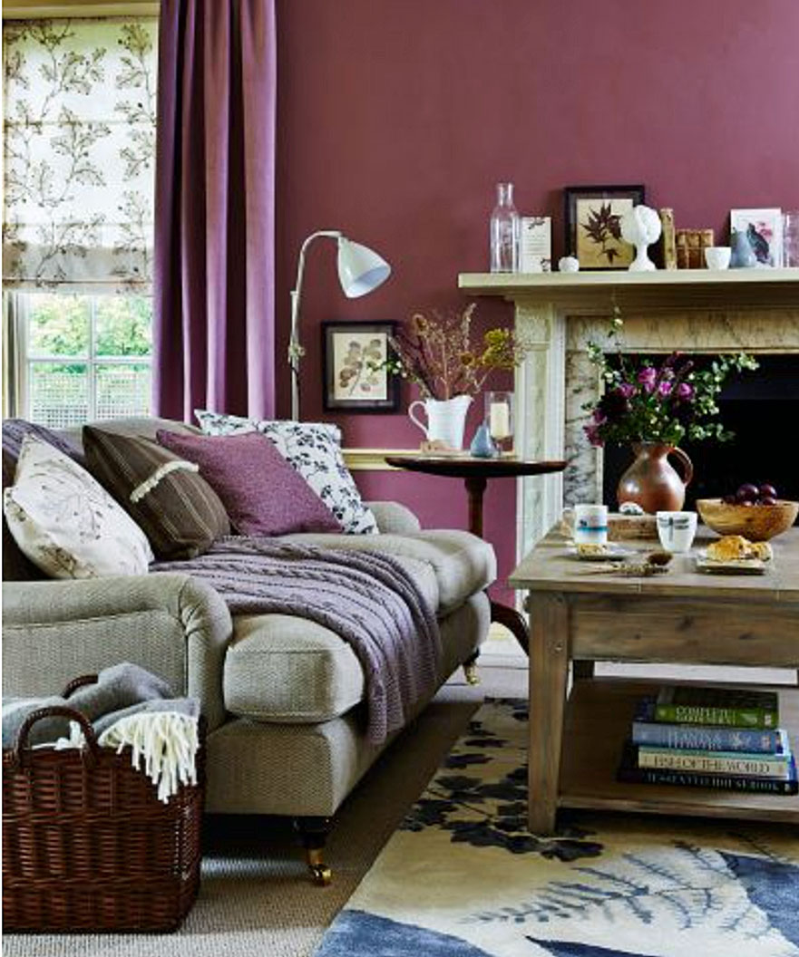 Living room color schemes in berry shades, with plum colored walls and earthy colored furniture.