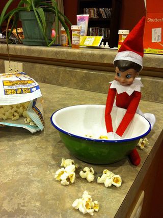 An Elf on the Shelf seems to have a hankering for popcorn.