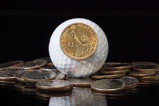 Money with golf ball GettyImages-459047367