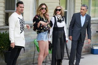 dan levy annie murphy catherine o'hara and eugene levy standing outside of a motel in fancy clothes in 'Schitt's Creek.'