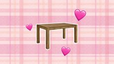 A brown dining table on a pink plaid background, with hearts around it