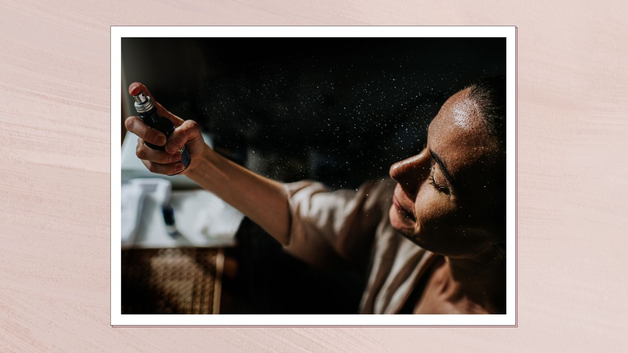 A woman is seen spraying a facial mist onto her skin/ in a pink template