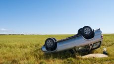 Car upside-down in a wheat field