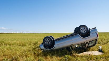 Car upside-down in a wheat field