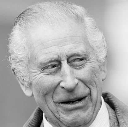 Black and white headshot of King Charles smiling