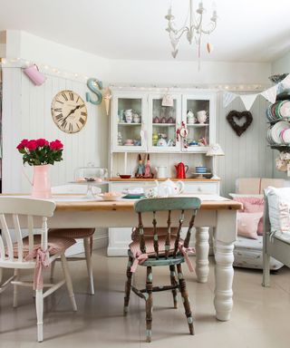 shabby chic dining room with a traditional wooden table French dresser and wooden wall panels