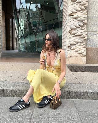 woman wearing yellow slip dress and sneakers outfit