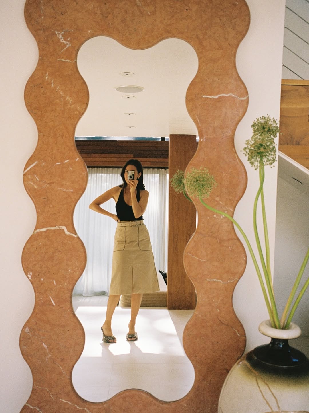 Woman wearing a camel colored skirt.