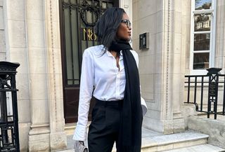 Woman in white shirt and black pants.