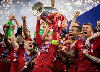 Liverpool captain Jordan Henderson lifts the Champions League trophy, 2019