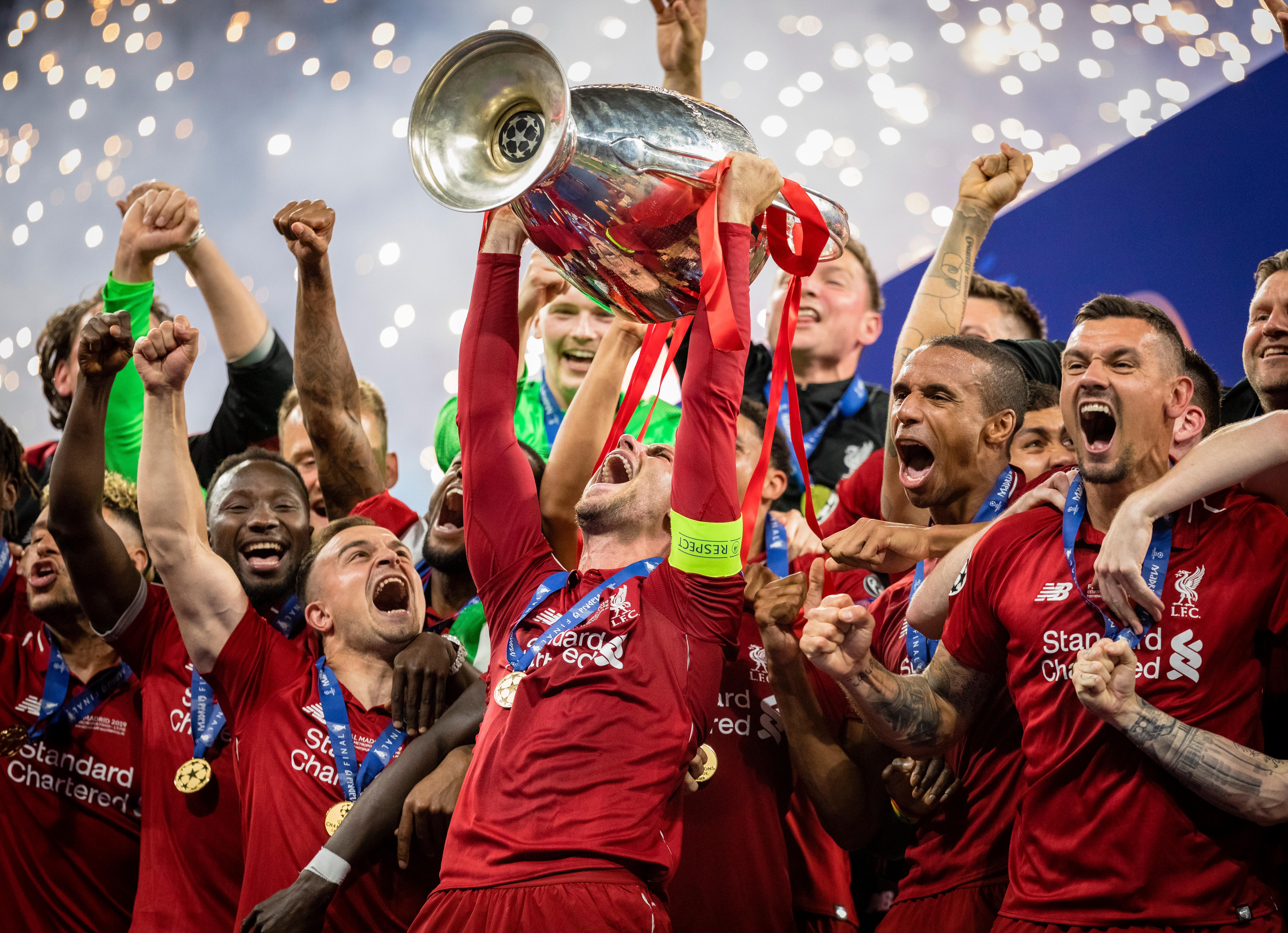 Liverpool captain Jordan Henderson lifts the Champions League trophy, 2019