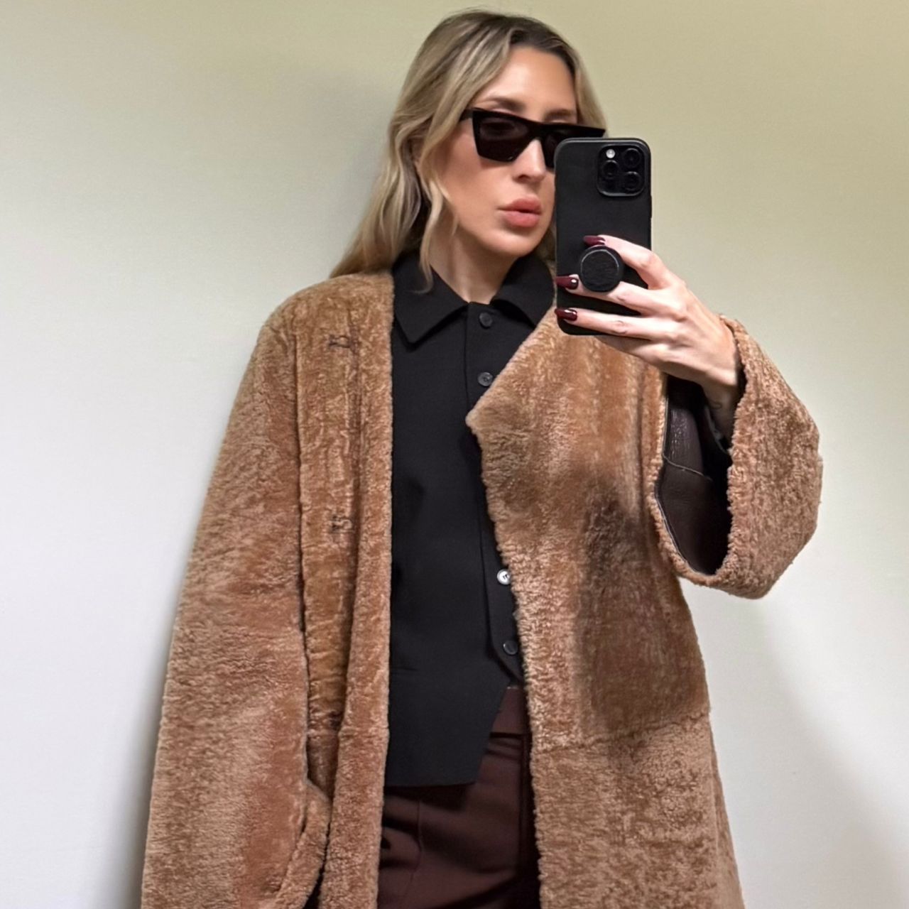 Angela Fink wearing a shearling coat