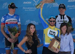 Kristin Bachochin (R), executive director and SVP of AEG Sports, awards Sir Bradley Wiggins of Great Britain riding for Team Sky the overall race leader's trophy for the 2014 Amgen Tour of California on May 18, 2014 in Thousand Oaks.