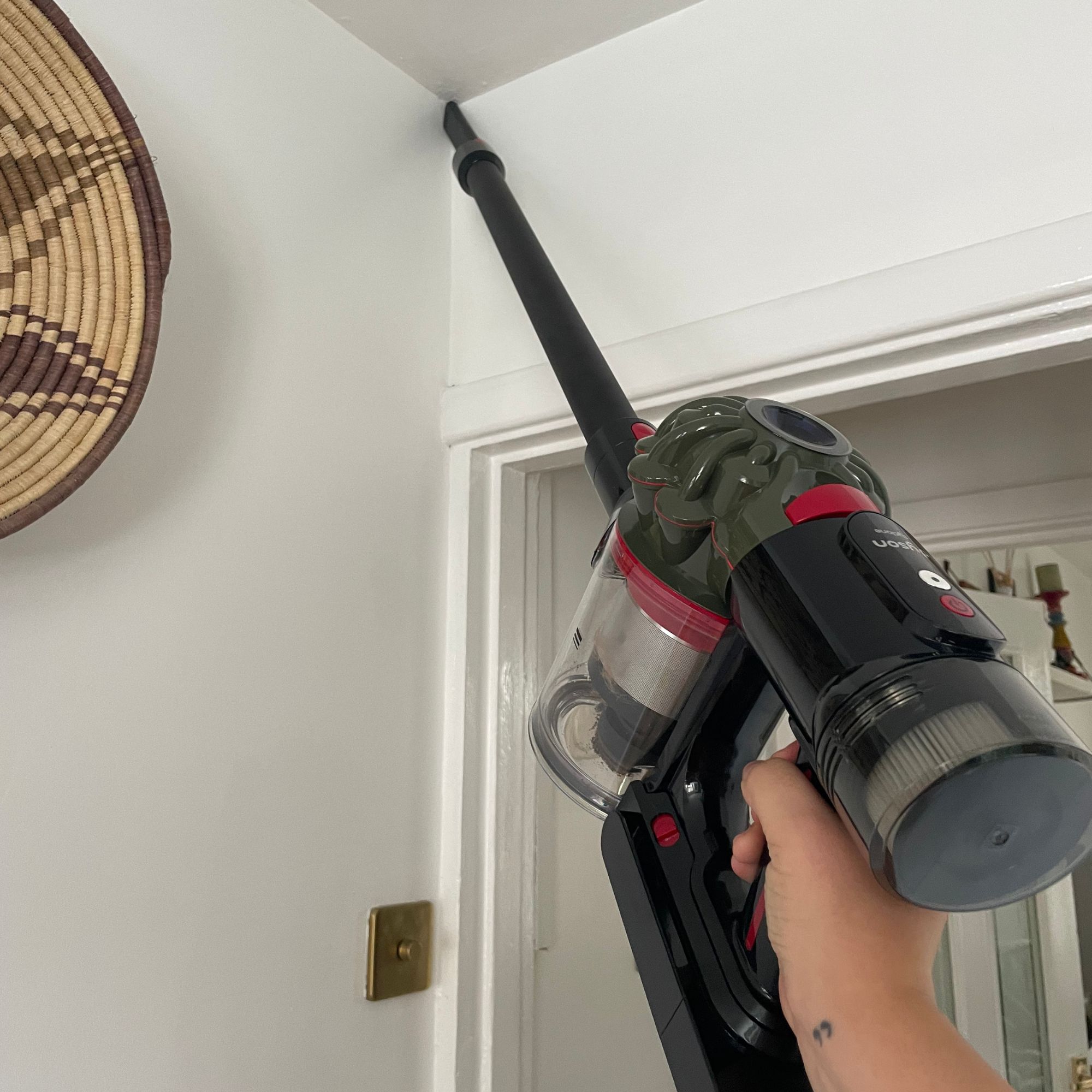 Using the Dyson V8 Cyclone and the crevice tool on the end of the extension wand to clean room corners