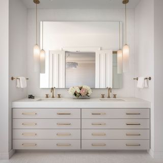 A built in bathroom vanity unit with double sink and cream drawers in a house which once belonged to Meg Ryan