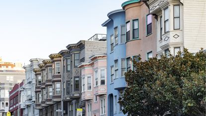 A row of historic pastel-colored buildings with classic bay windows in San Francisco, Calif.
