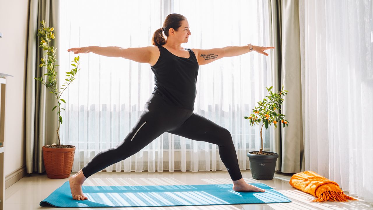 Woman practicing yoga at home