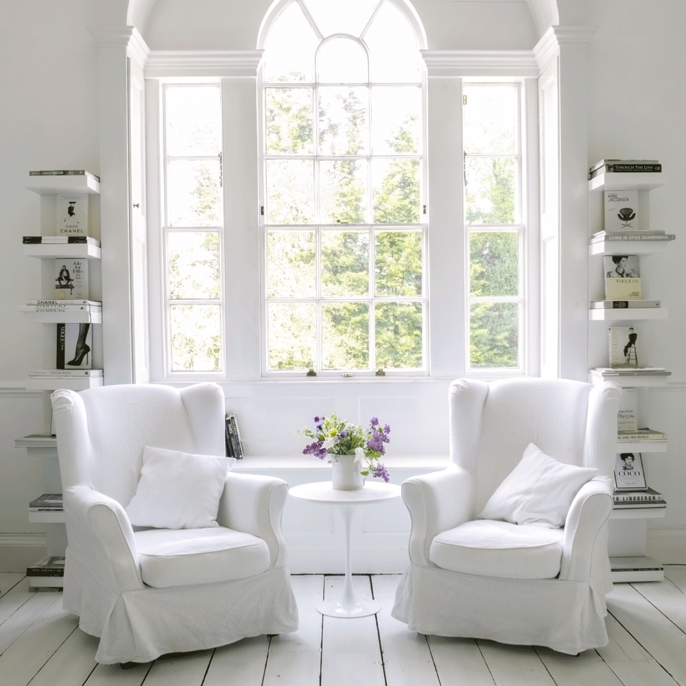 living room with white sofa cushion books and table