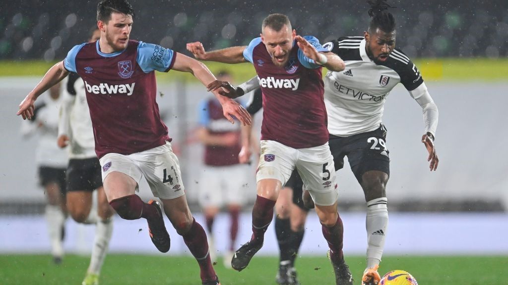 Fulham&#039;s Cameroonian midfielder Andre-Frank Zambo Anguissa (R) takes on West Ham United&#039;s Czech defender Vladimir Coufal (C) and West Ham United&#039;s English midfielder Declan Rice (L) during the English Premier League football match between Fulham and West Ham United at Craven Cottage in London on February 6, 2021