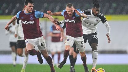 Fulham's Cameroonian midfielder Andre-Frank Zambo Anguissa (R) takes on West Ham United's Czech defender Vladimir Coufal (C) and West Ham United's English midfielder Declan Rice (L) during the English Premier League football match between Fulham and West Ham United at Craven Cottage in London on February 6, 2021