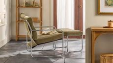 Joanna Gaines' mid-century-style chrome accented, green upholstered armchair and ottoman duo pictured in a sunlit living room flooded with natural light 