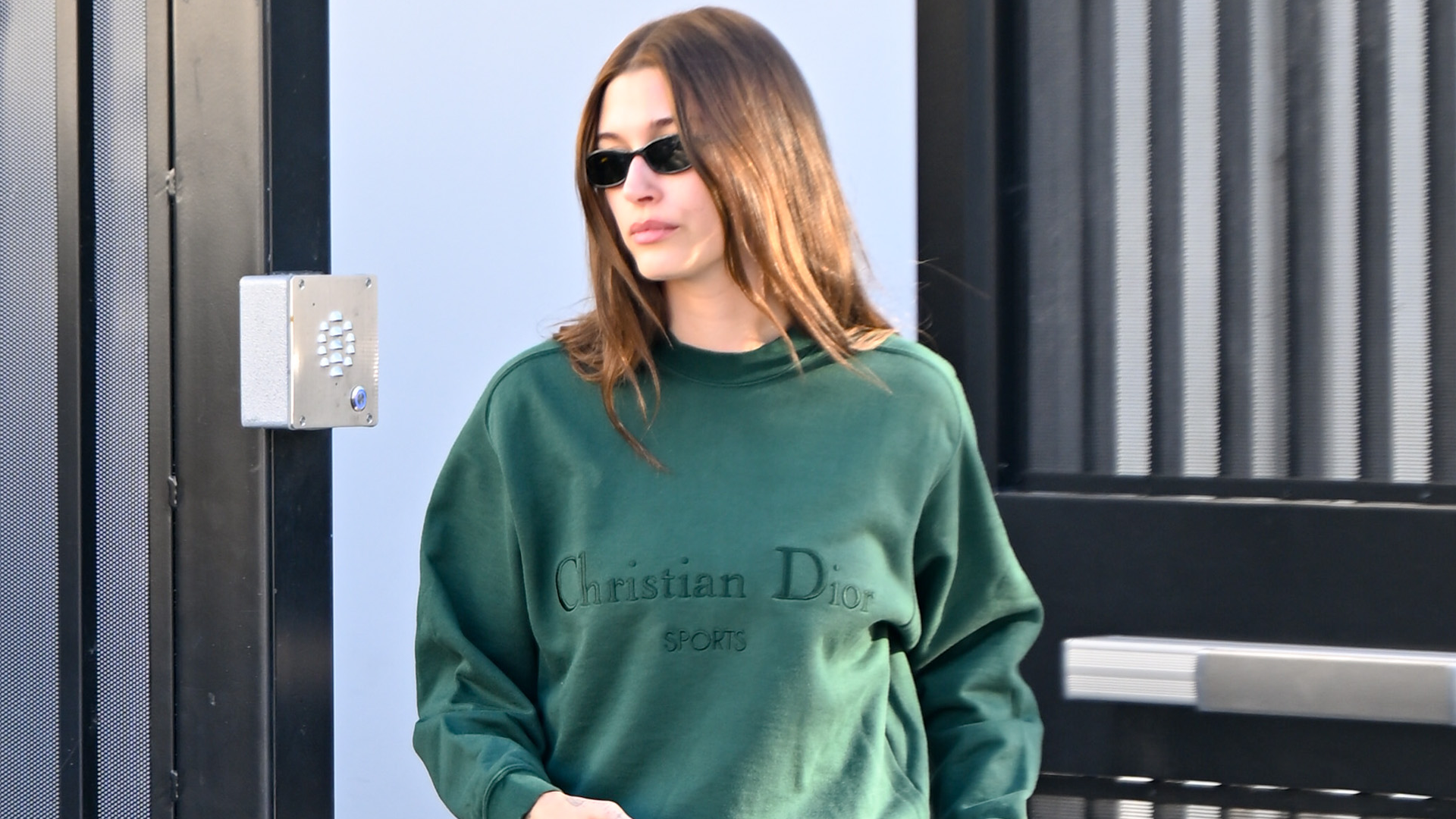 Hailey Bieber styled an oversize Dior sweatshirt with wide-leg jeans and a Dior bowling bag