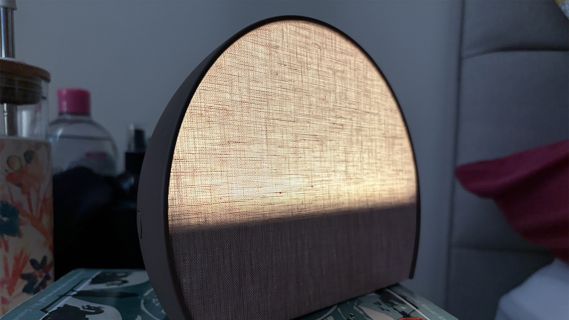 The Hatch Sleep Clock glowing gently in a semi-dark room