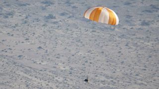 The training model of the sample return capsule floats downward during a drop test on Wednesday, Aug. 30, 2023