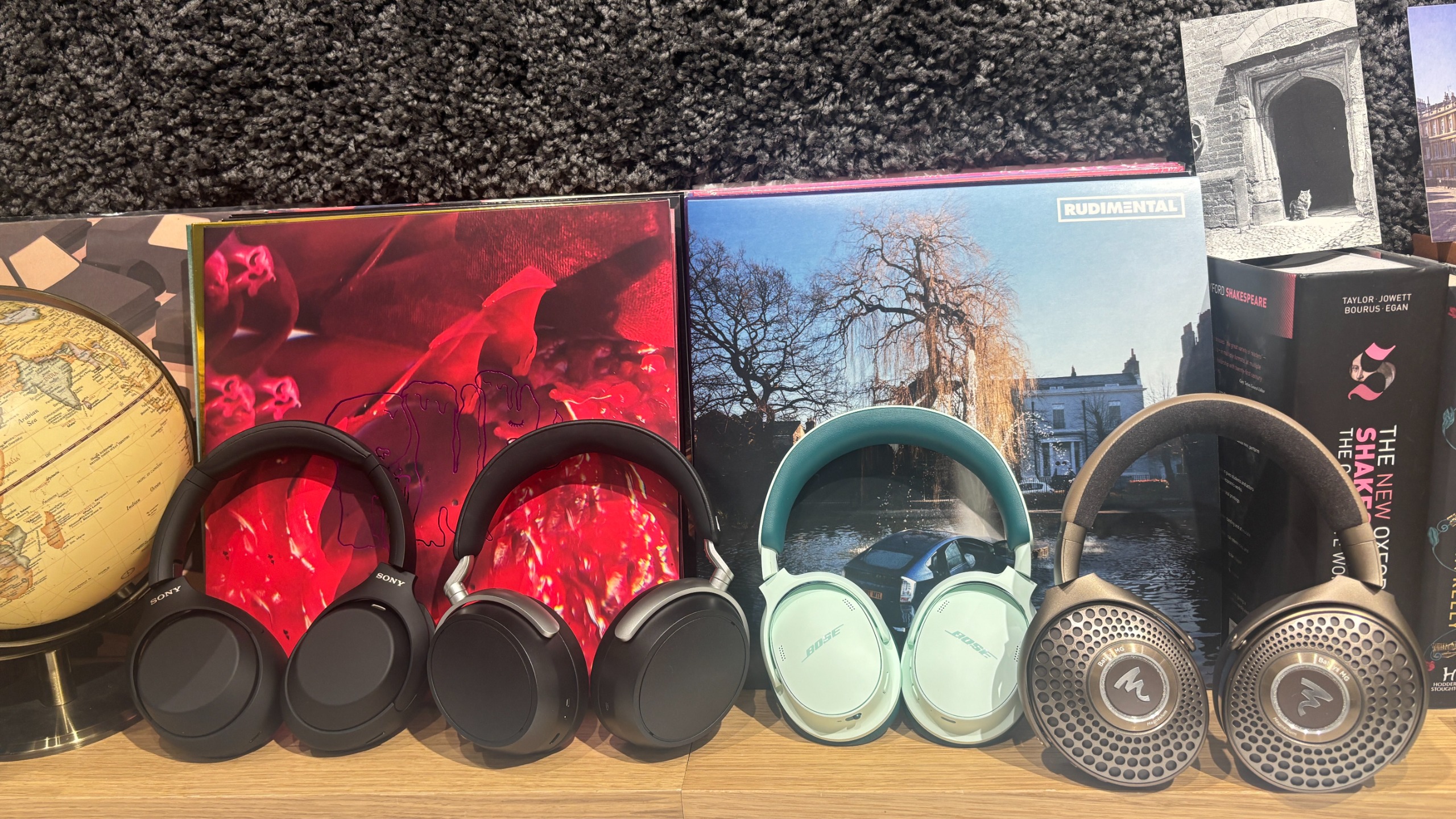 An array of wireless headphones from various brands in a test room