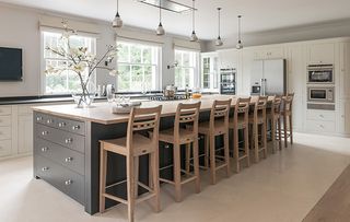 In this Sims Hilditch design a row of chairs transforms an island into a dining table where guests can chat to the chef as dinner is prepared