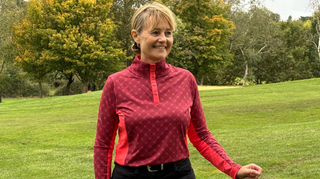 A golfer wears the Ping Lolette Ladies Printed Long Sleeve Top